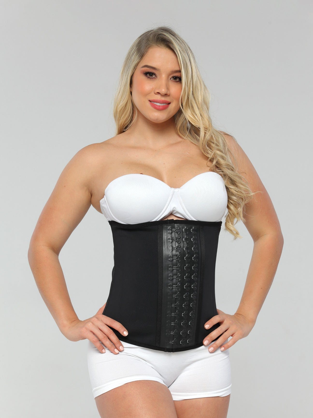 Black Colombian latex waist trainer with adjustable hook-and-eye closure and high compression, front view