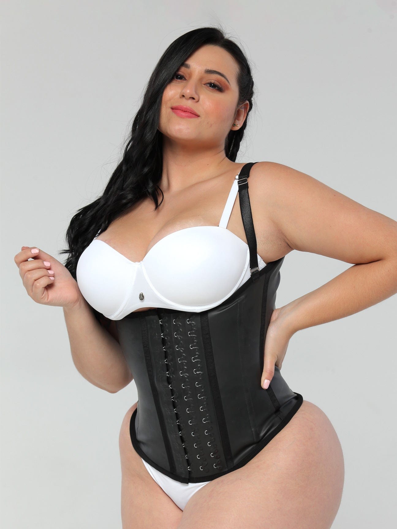 Front view of a plus sized model wearing the semi vest latex waist trainer.
