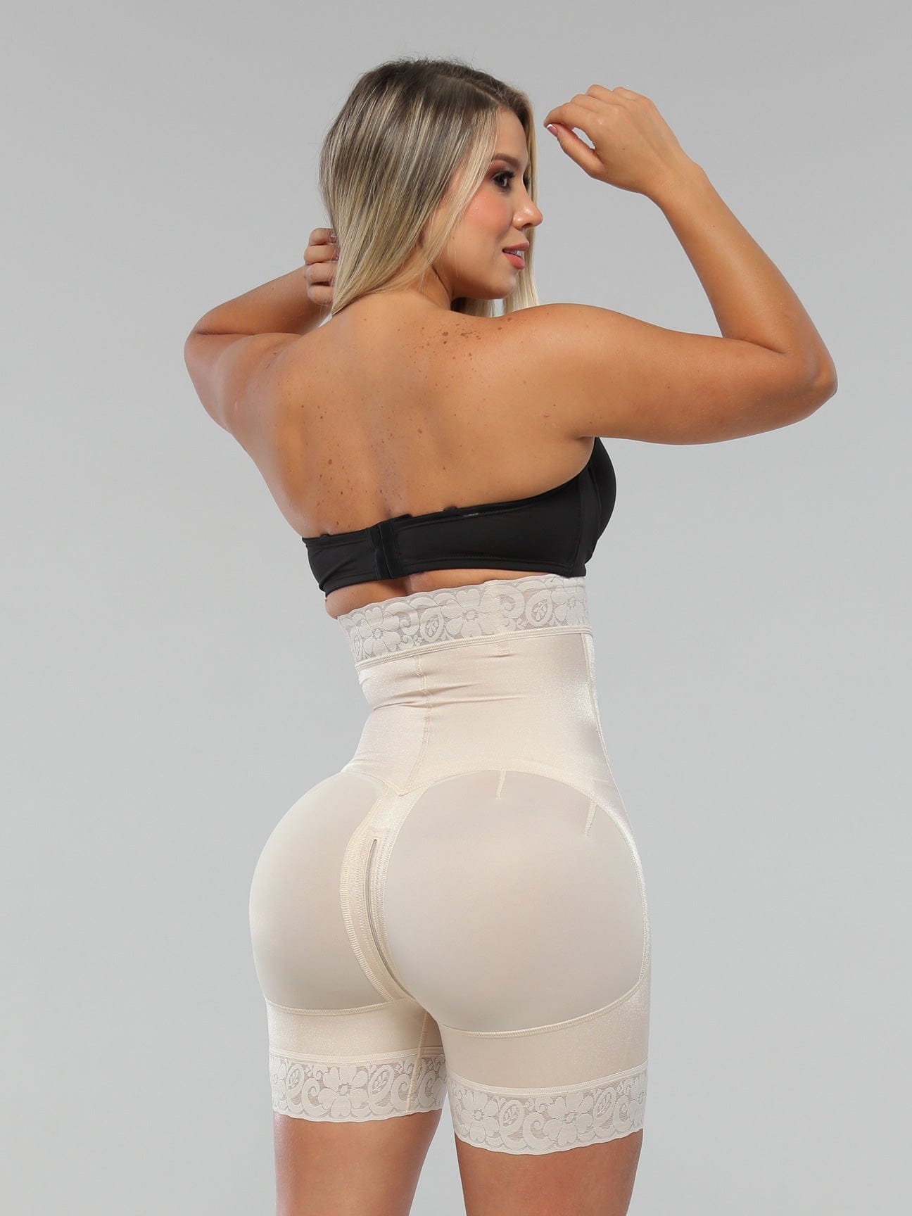 Beige Colombian strapless faja shapewear bodysuit with butt-lifting panels and medium waist compression, back view