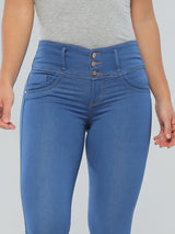 Blonde Latina woman wearing high-waisted skinny blue butt lift jeans with thick waistband for no waist gap.