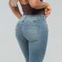 Waist view of a model weaing a blue faded butt lifting jeans with back pockets