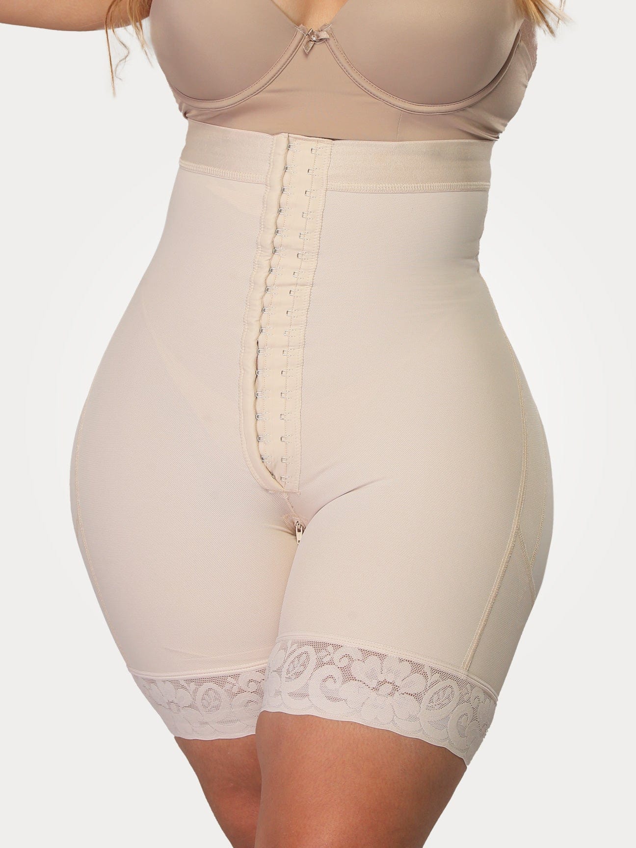 Beige Colombian high-waisted strapless faja with adjustable hook-and-eye closure, front view