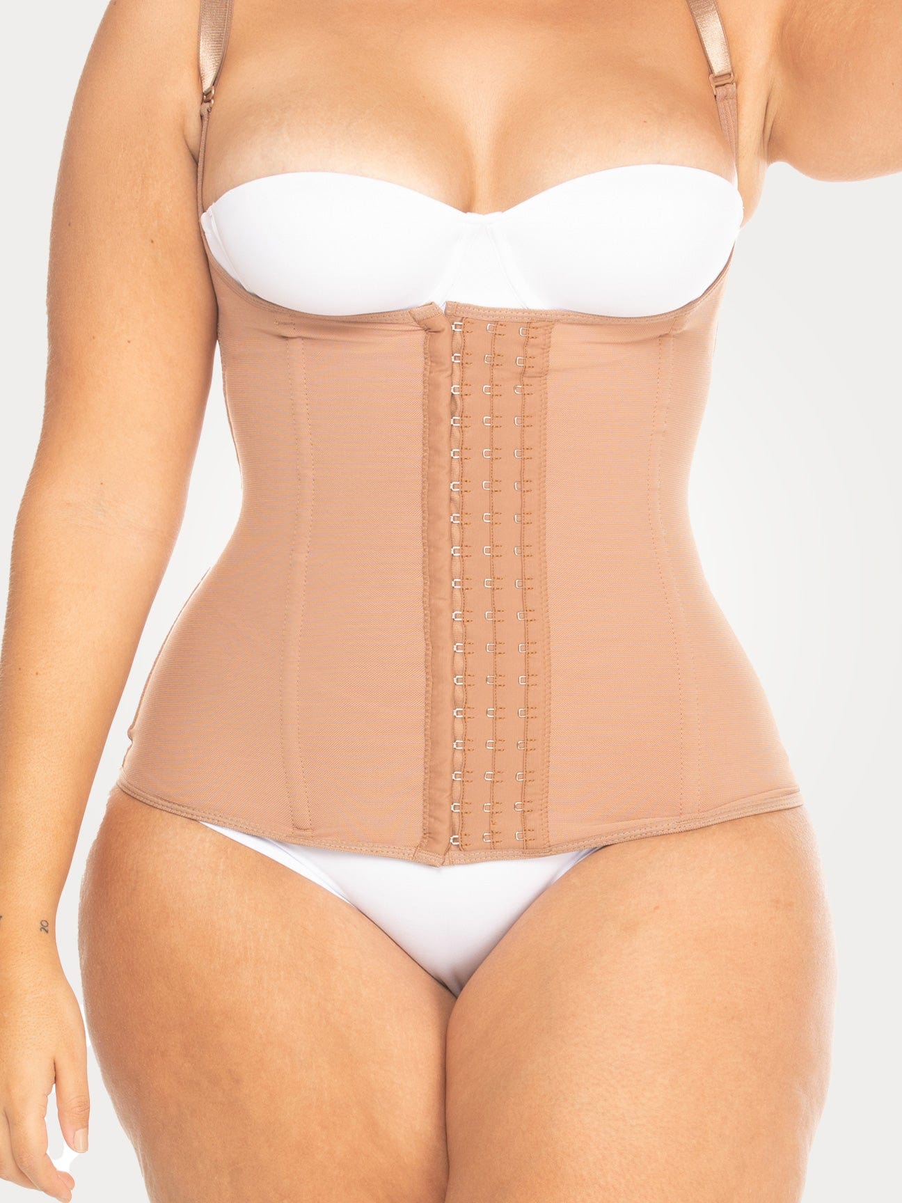 Model wearing a nude Ultra-Sculpt Waist Trainer with hooks, showing a smooth and defined midsection