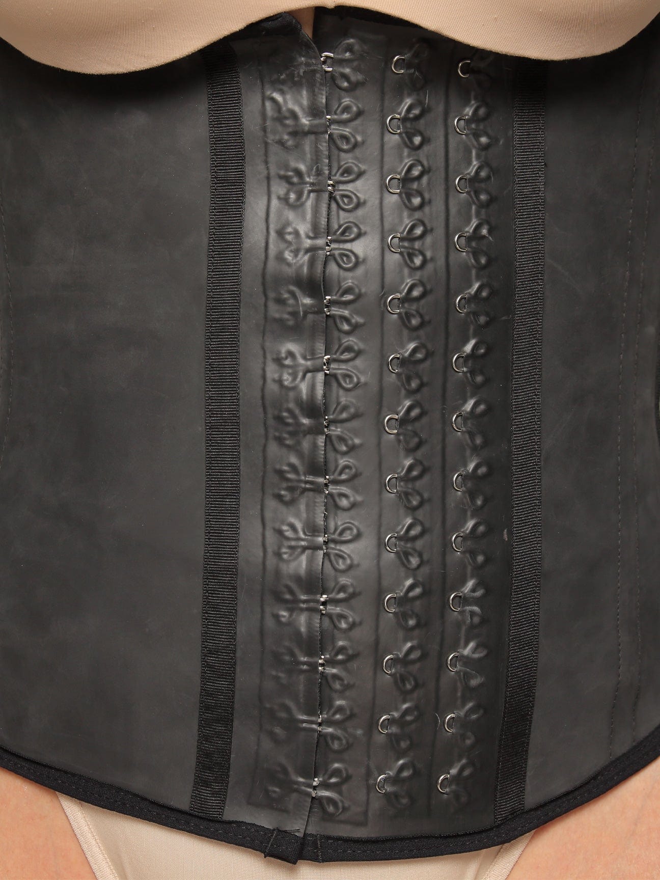 Close up view of the central hooks of the semi vest latex waist trainer.