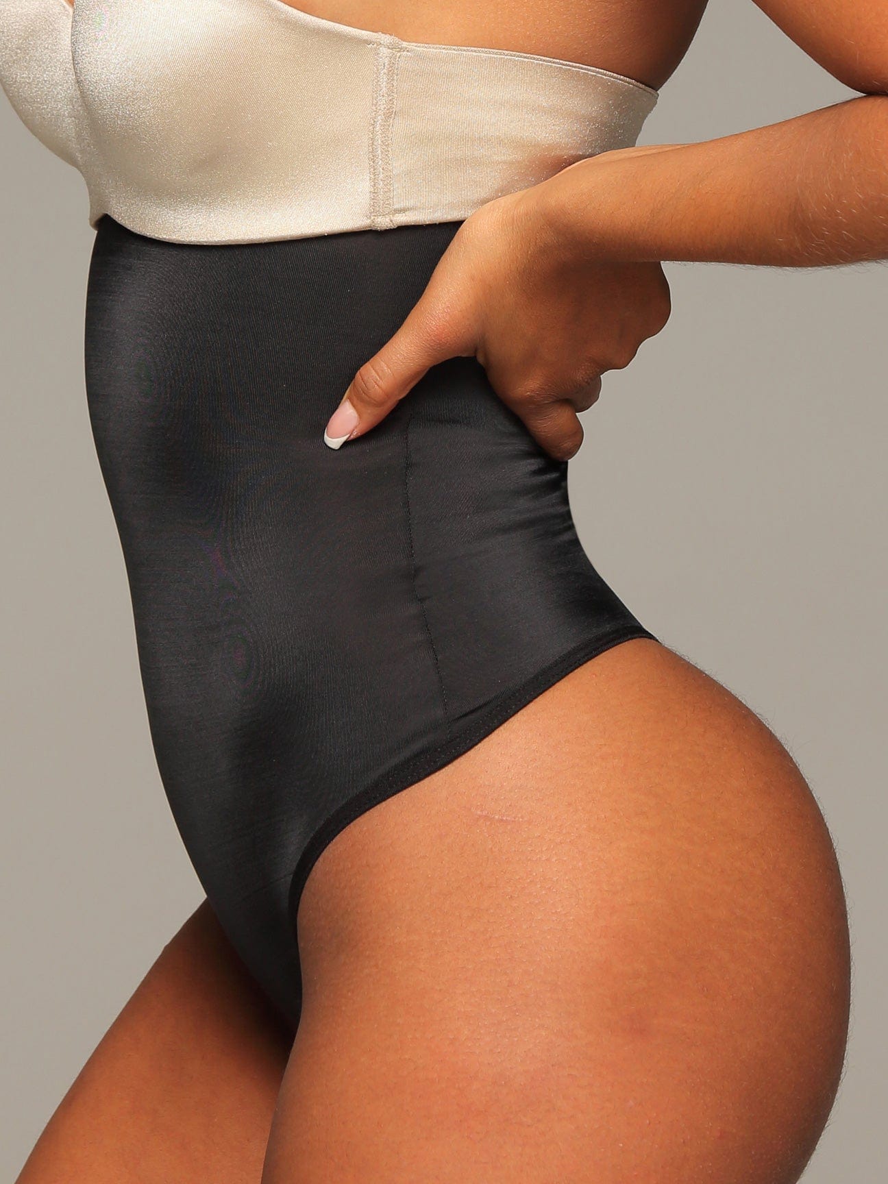 Black Colombian strapless faja bodysuit with light compression, side view