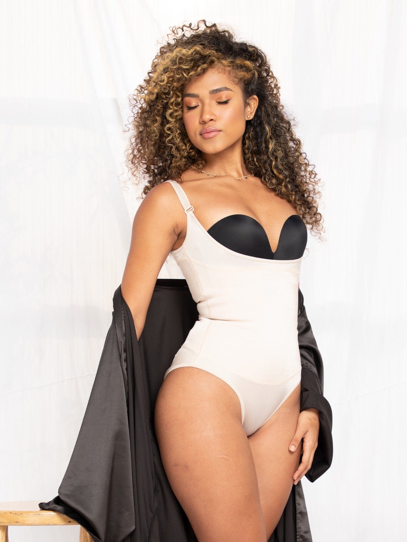 Model wearing a night gown and the white version of the body suit shaper with thong.
