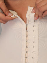 Beige Colombian high-waisted strapless faja with adjustable hook-and-eye closure, close-up