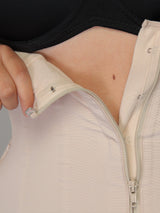 Beige Colombian faja waist trainer zipper and internal hook-and-eye closure, close-up