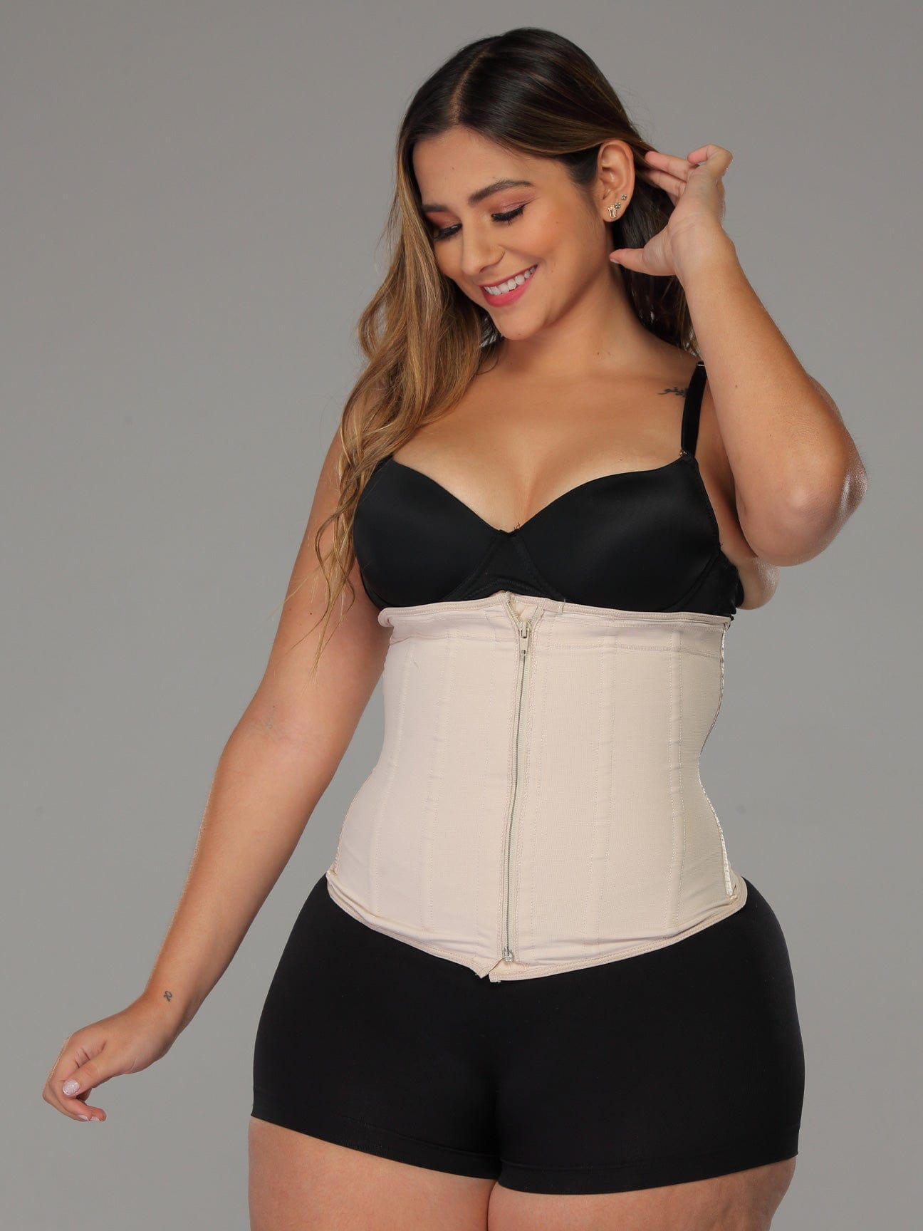 Beige Colombian faja waist trainer with zipper and high compression, front view