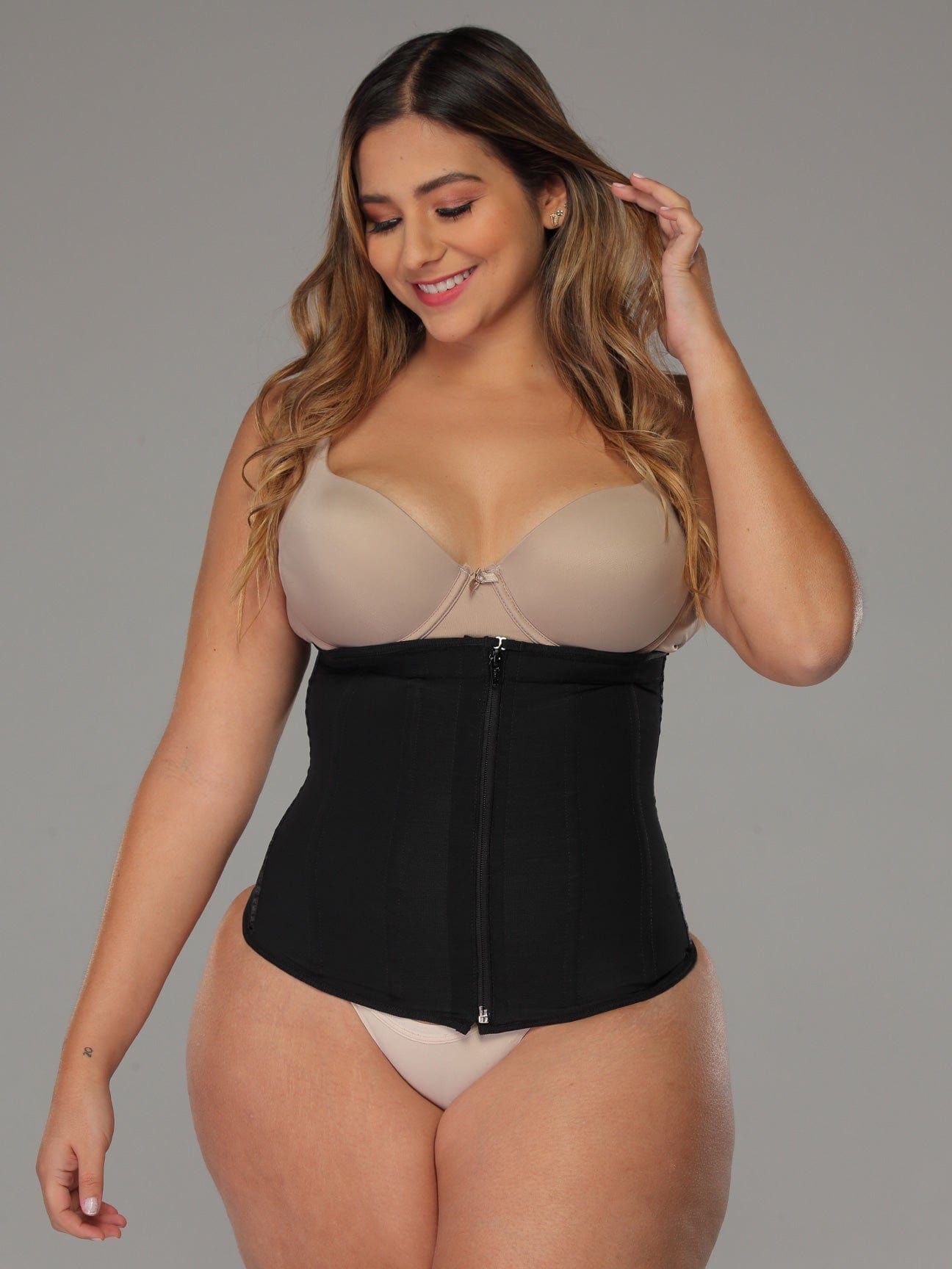 Black Colombian faja waist trainer with zipper and high compression, front view